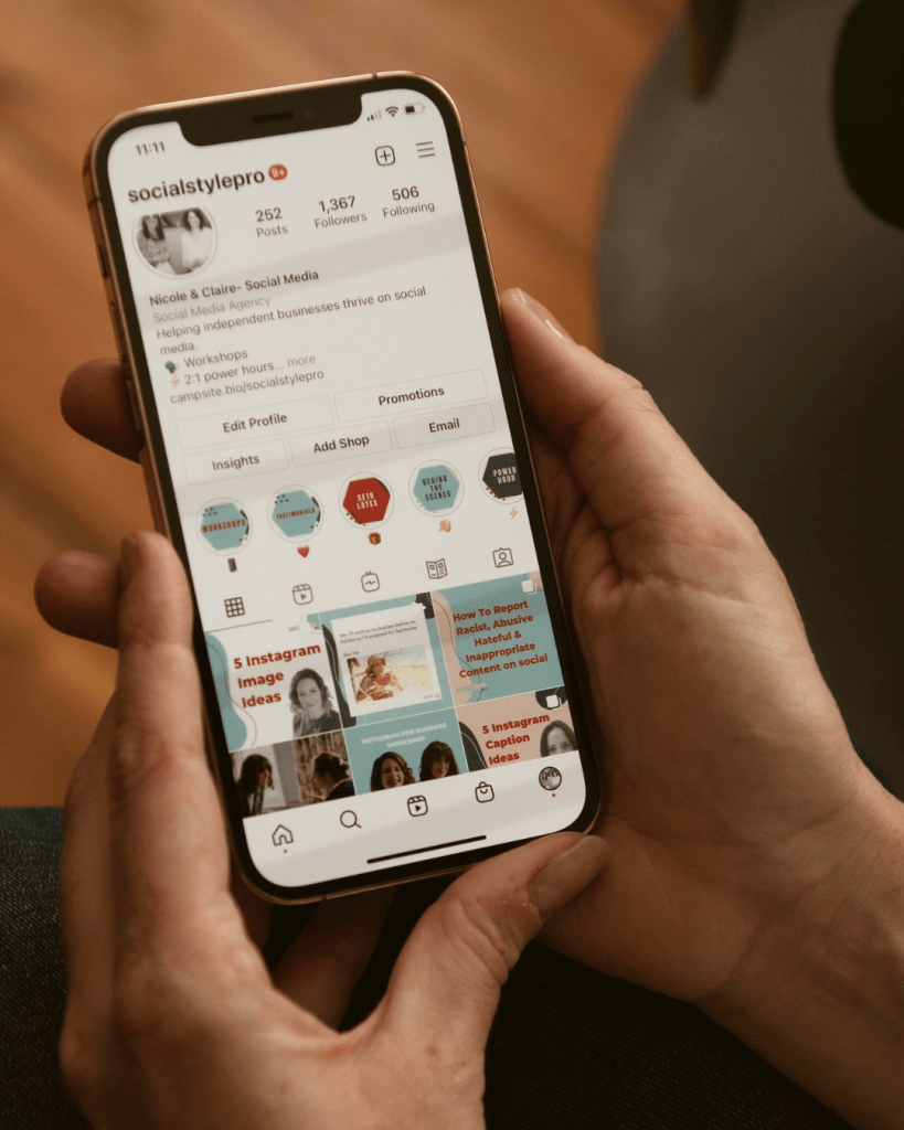 phone with screen showing Social Style Pro Instagram account
